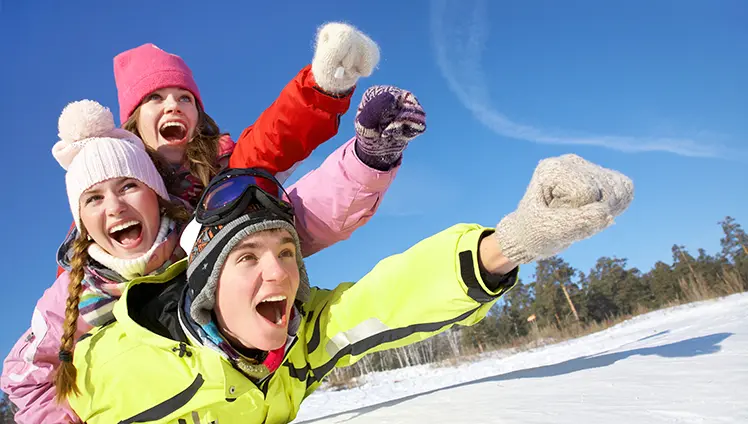 A group of people bundled up and playing in the snow.