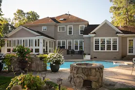Backyard with greenery and swimming pool.