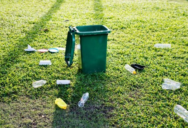 Empty bottles surruonding open trash can