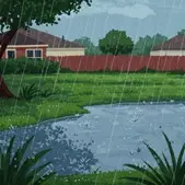 Raining in field with pond. Homes in the background behind a fence. 
